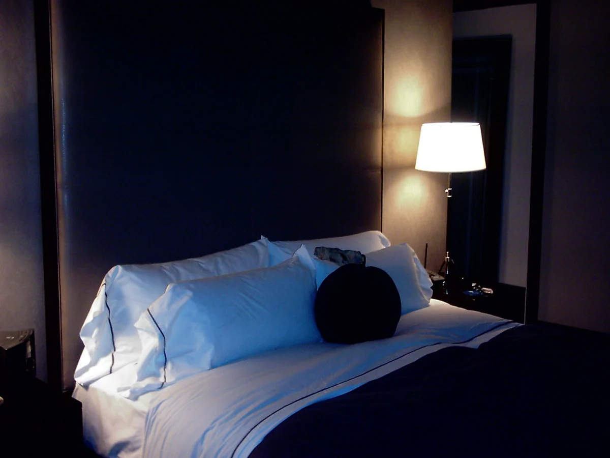 Bedroom prepared for arrival with warm lighting