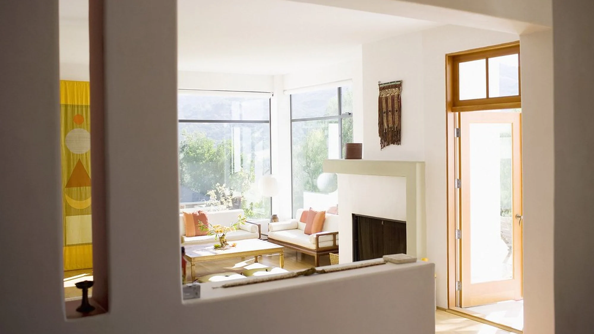 Sunlit living room in a furnished apartment with a city view